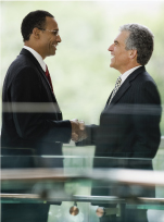 Two men in suits shaking hands